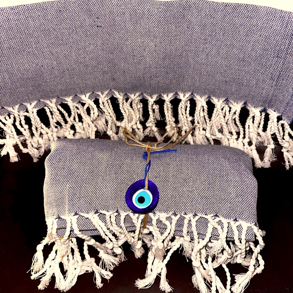 High absorption, light weight towel with an evil eye charm.